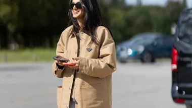 A woman wearing a Prada barn jacket at Paris fashion week.