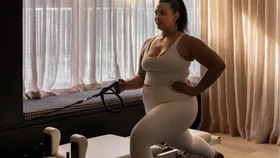 Woman using a reformer Pilates machine at home