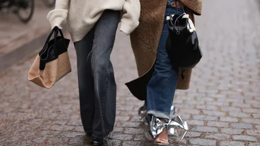 Two people walking together outside the Skall Studio show at Copenhagen Fashion Week 2024