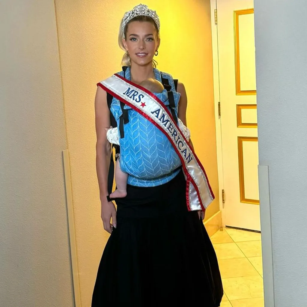 Hannah Neeleman or Ballerina Farm posing post-Miss America win with one of her children.