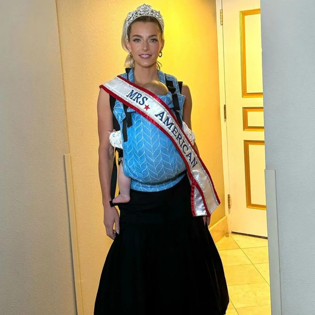 Hannah Neeleman or Ballerina Farm posing post-Miss America win with one of her children. 