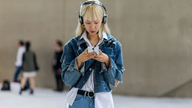 Girl with bleached hair listening to music on headphones