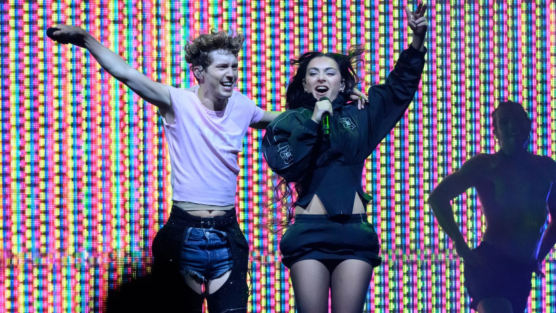 troye sivan and charli xcx with their arms around each other on stage during the sweat tour 2024