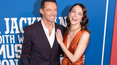 A man and woman holding each other and smiling.