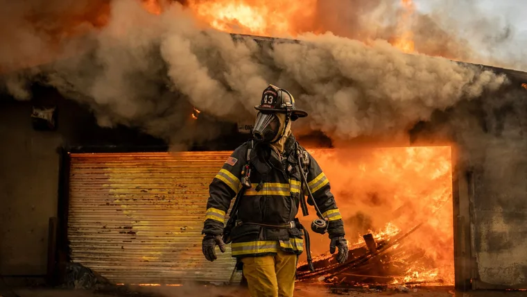 Firefighters work to put out a fire that broke out at the Altadena Golf Course Jan.09, 2025.