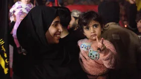 woman and child in palestine celebrate gaza ceasefire agreement