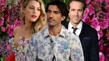 Two men wearing suits and a blonde woman staring standing shoulder to shoulder.