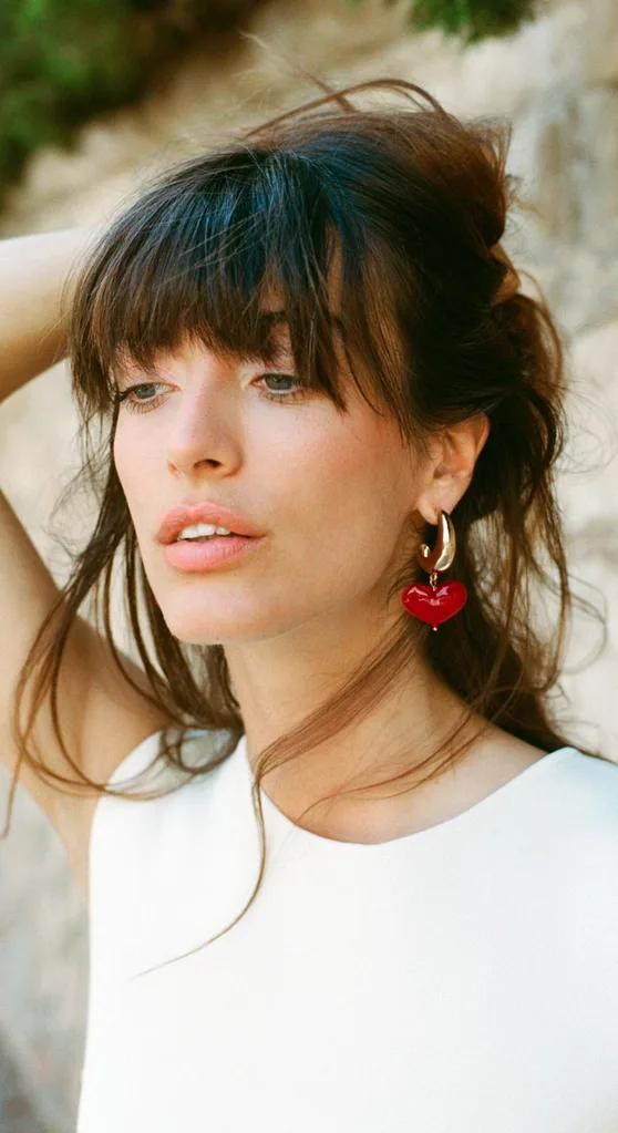 Woman wearing earrings with red hearts