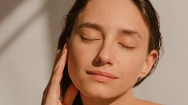 Woman touching her face