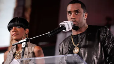 Dawn Richards and P Diddy standing in front of a microphone at a press conference in 2010.