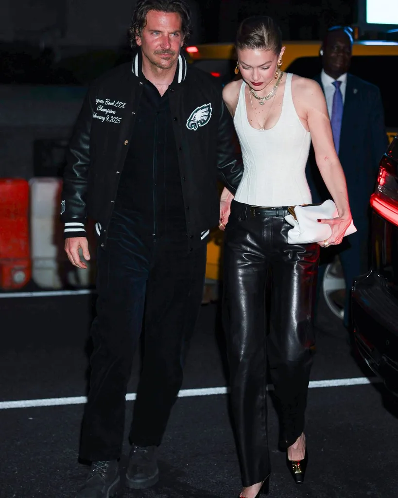 Bradley Cooper and Gigi Hadid walking together.