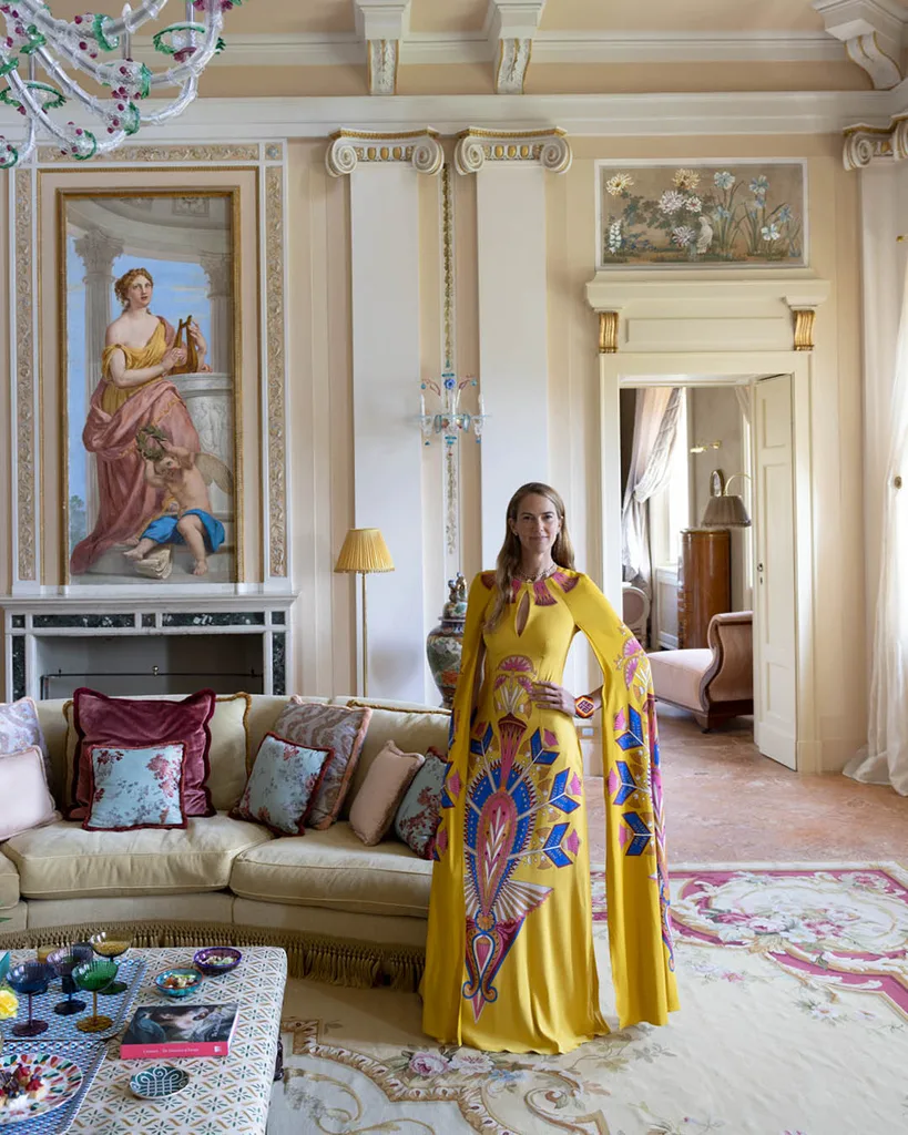 La DoubleJ designer JJ Martin standing inside the living area of luxury hotel Passalacqua