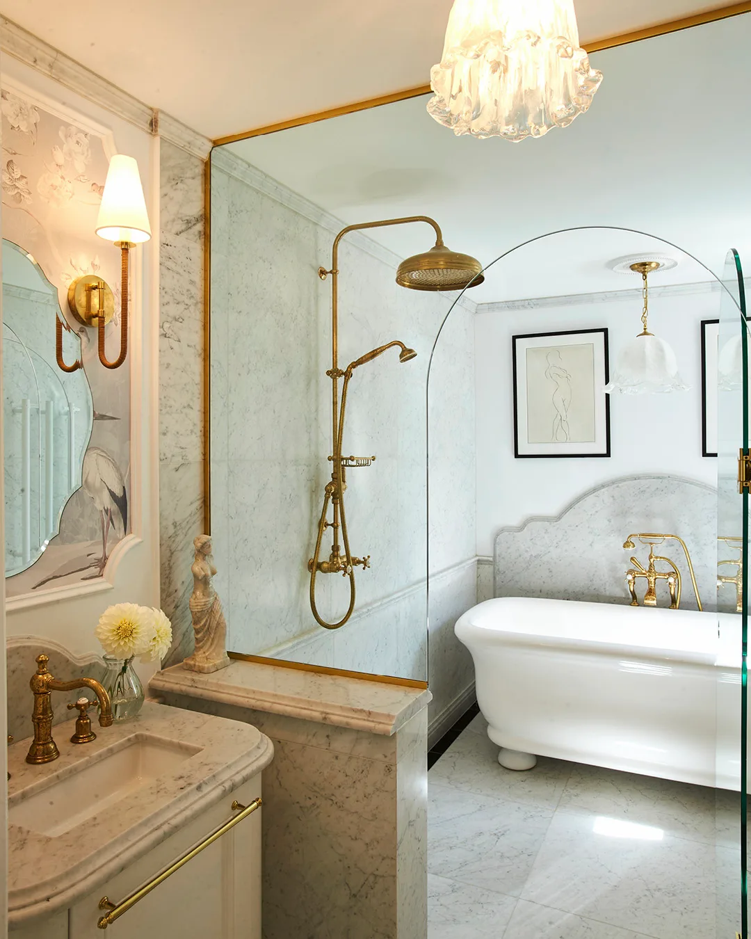 A bathroom with gold shower fittings and a freestanding bath. 
