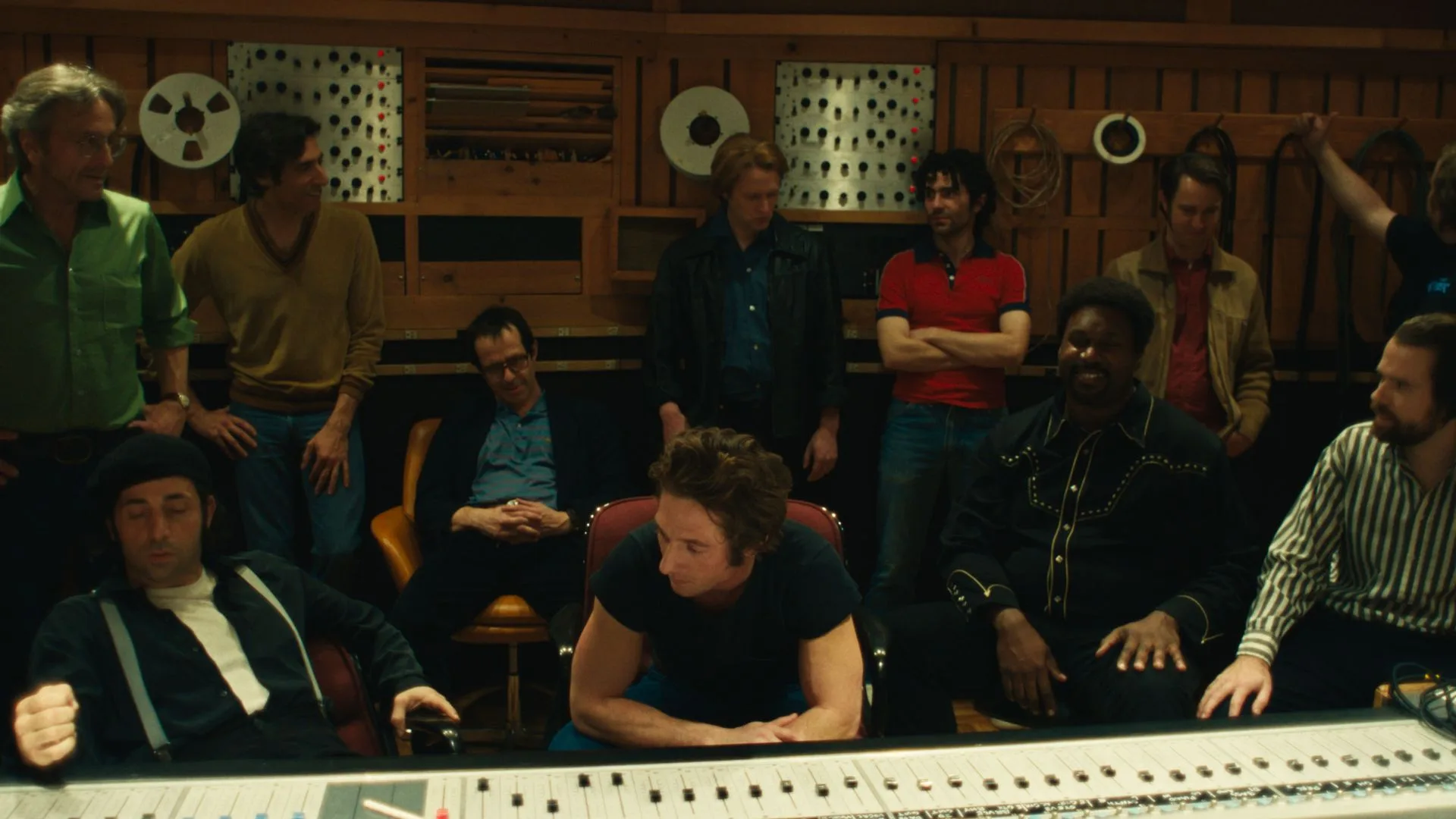 A group of men in a recording studio. 