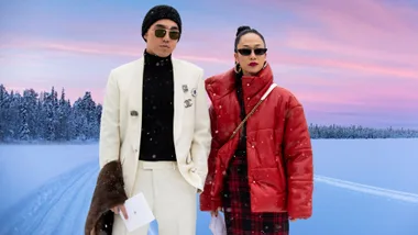 couple stand in the snow on the street