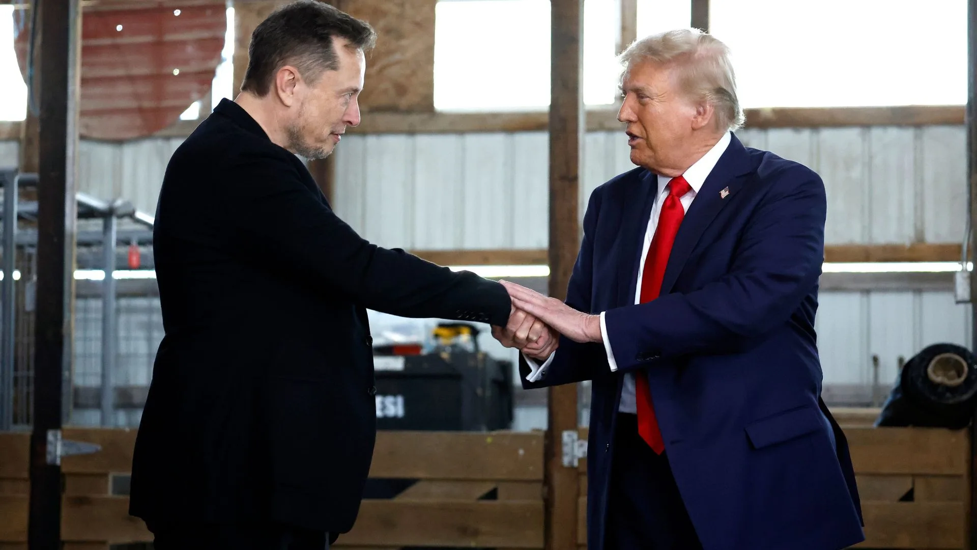 Two men holding hands. 