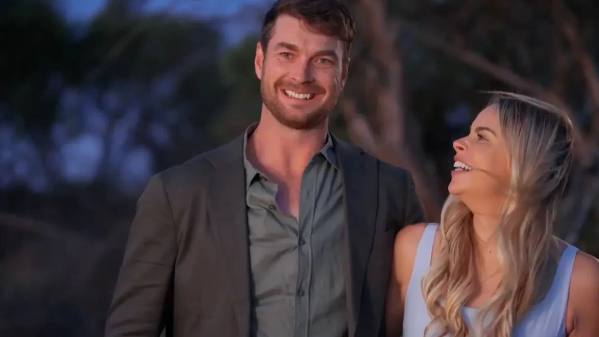 A man and a woman smiling at each other. 