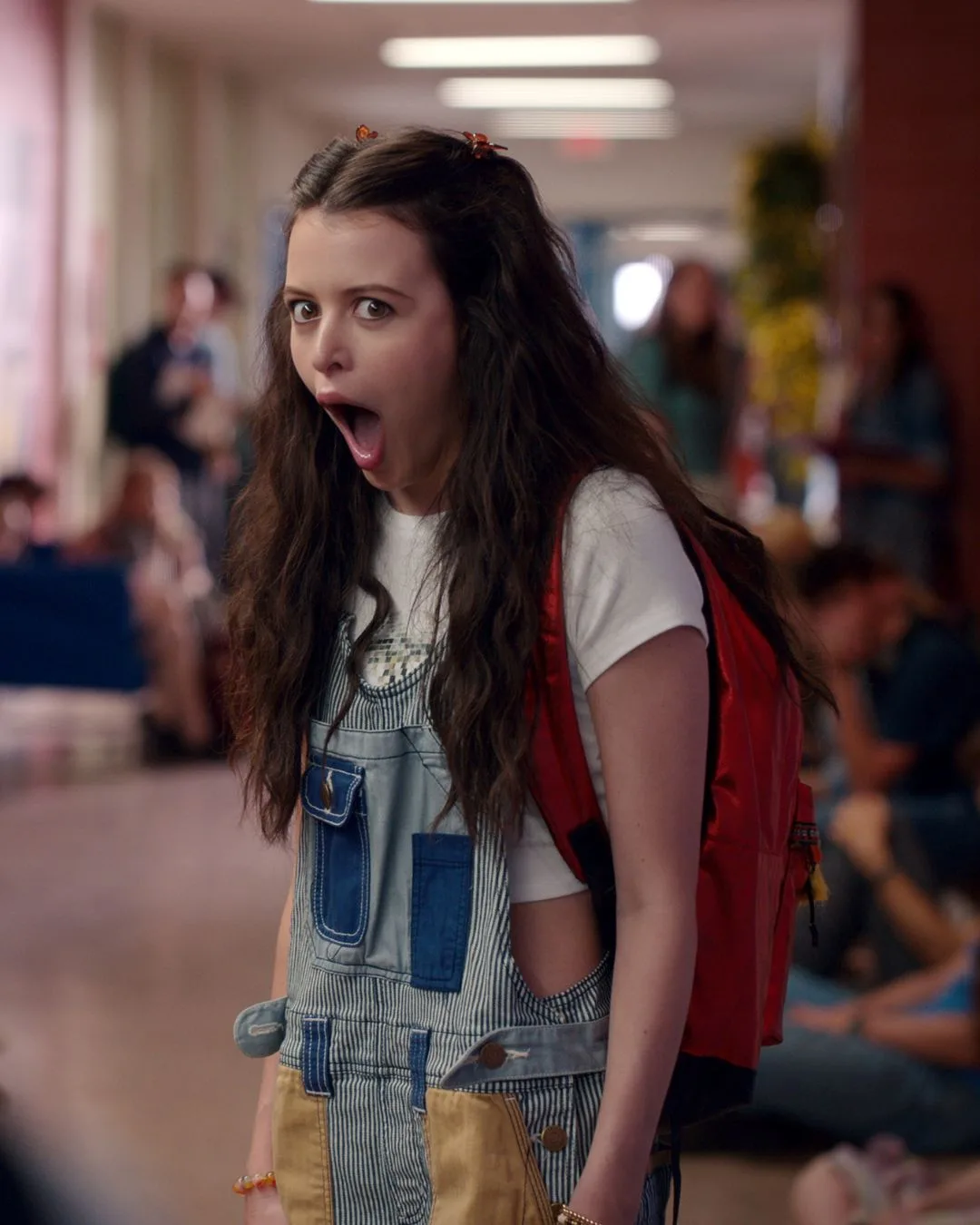 A young brunette woman looking shocked.