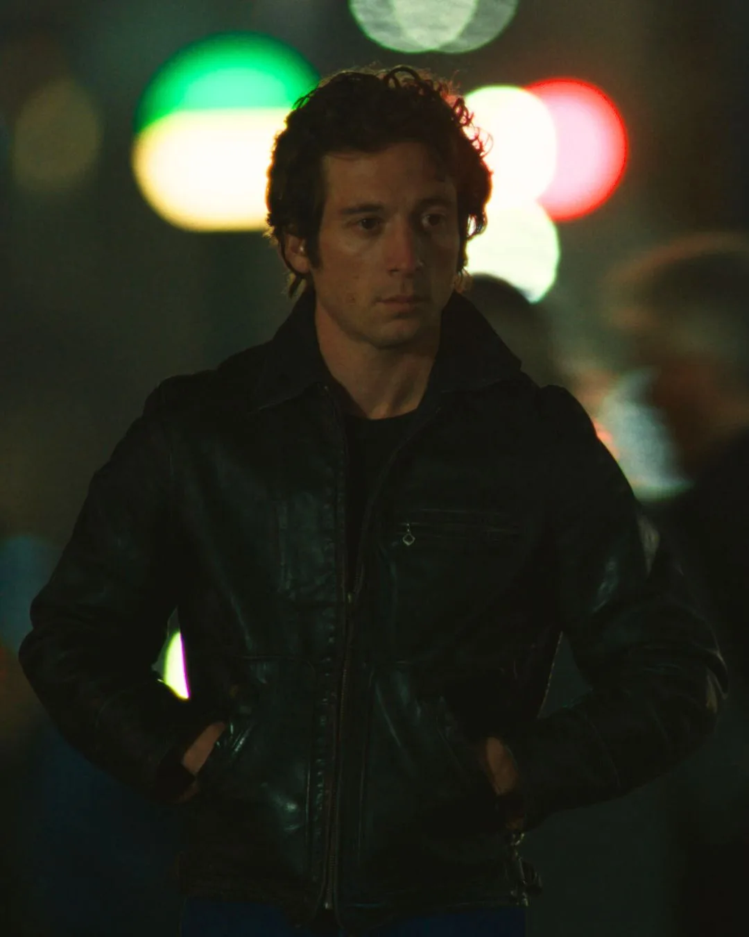 A man walking in a dimly lit street. 