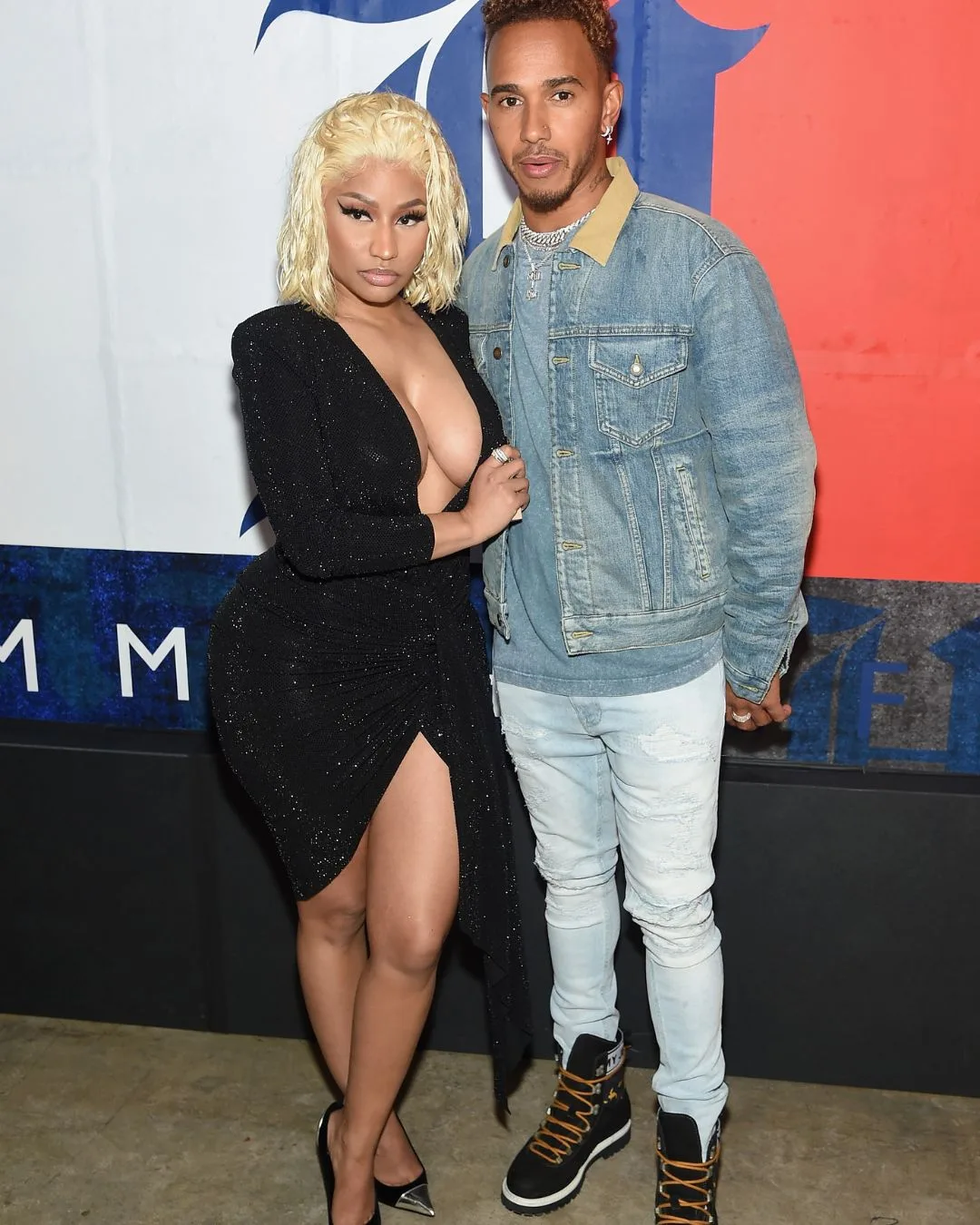 A man and a woman posing at an event. 