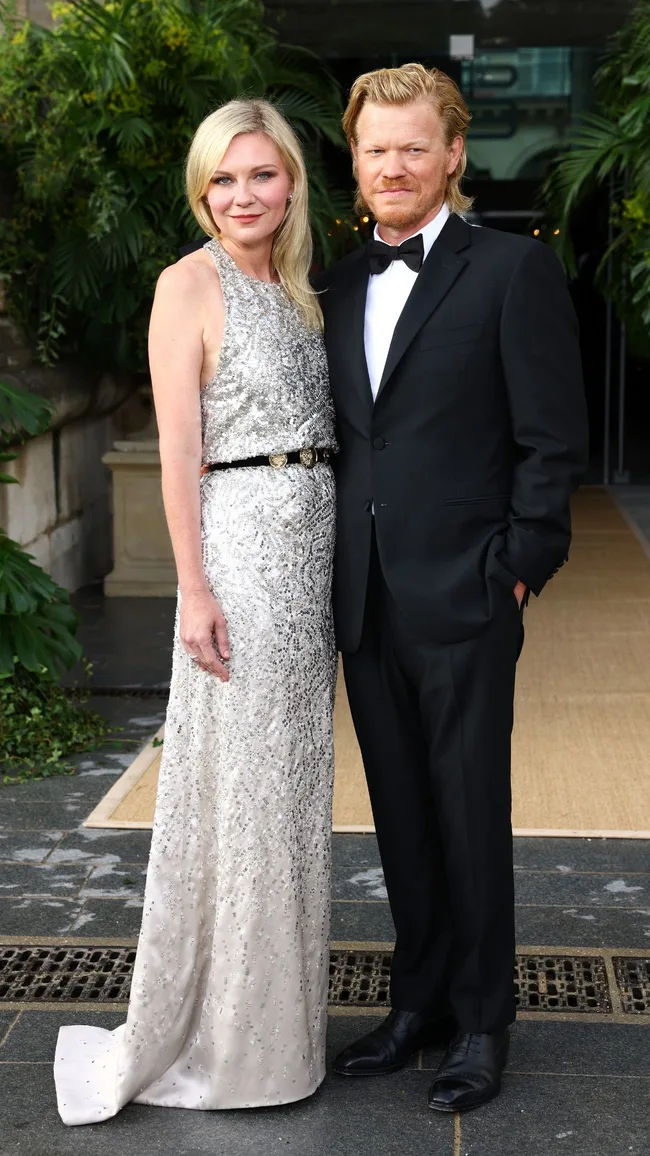 A man and woman wearing formal attire.