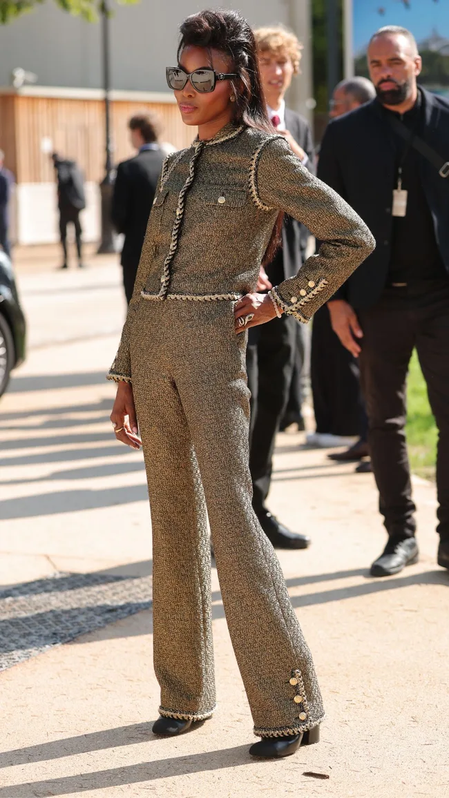 A woman wearing a khaki coloured suit.