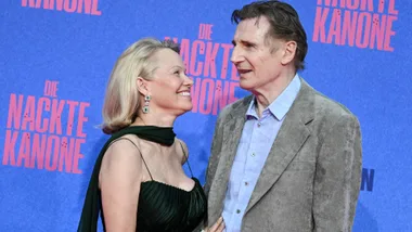A woman looking lovingly at a taller man.