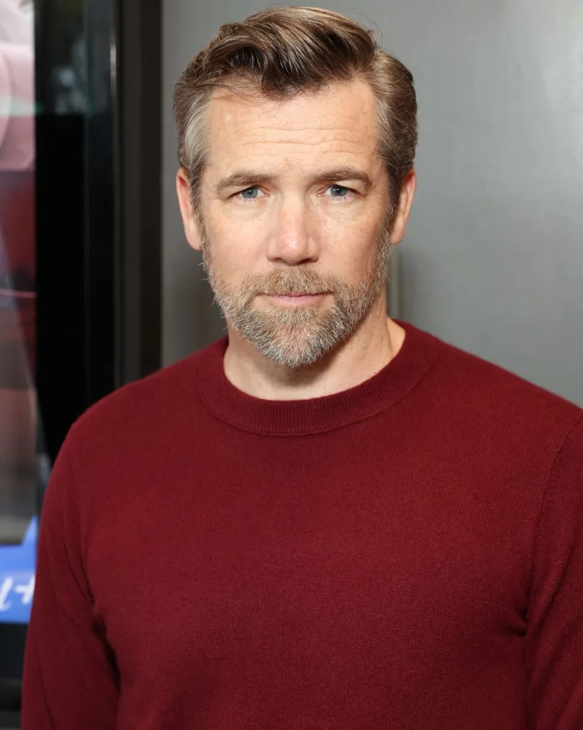Actor Patrick Brammell wearing a dark red sweater.