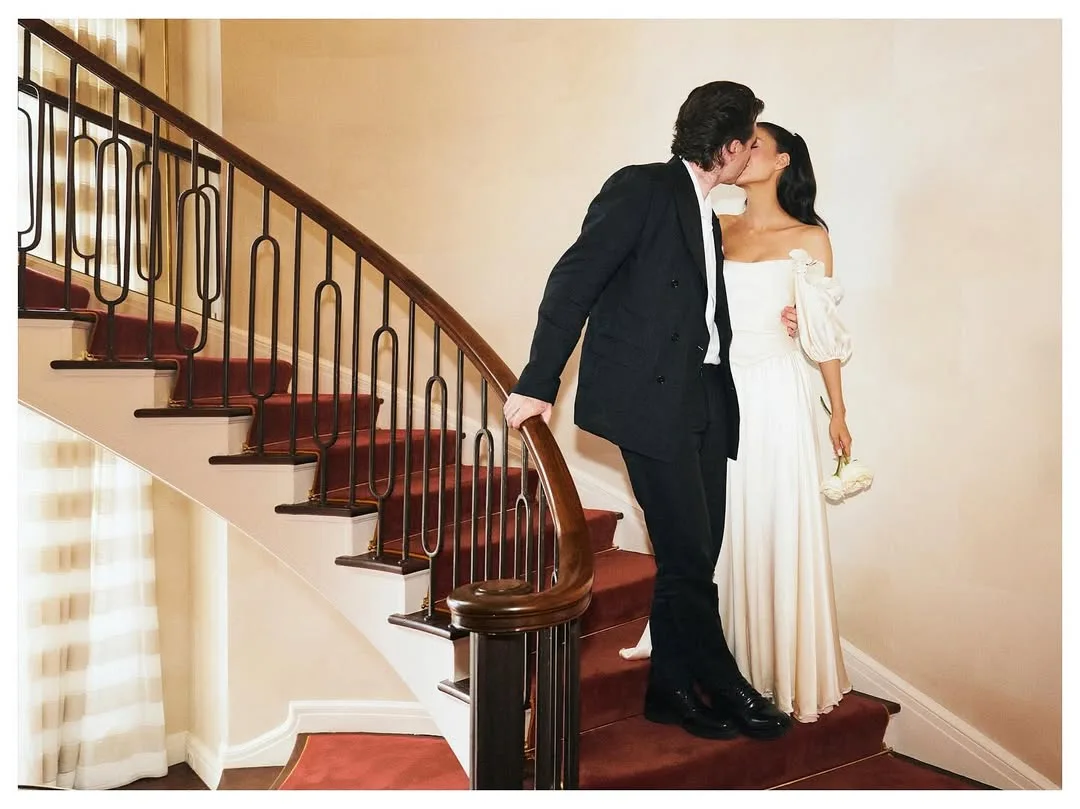 Nicola Peltz and Brooklyn Beckham kiss on the stairs at their second wedding