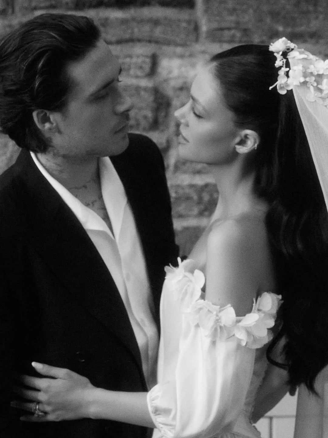 a black and white photo of Nicola Peltz and Brooklyn Beckham at their second wedding