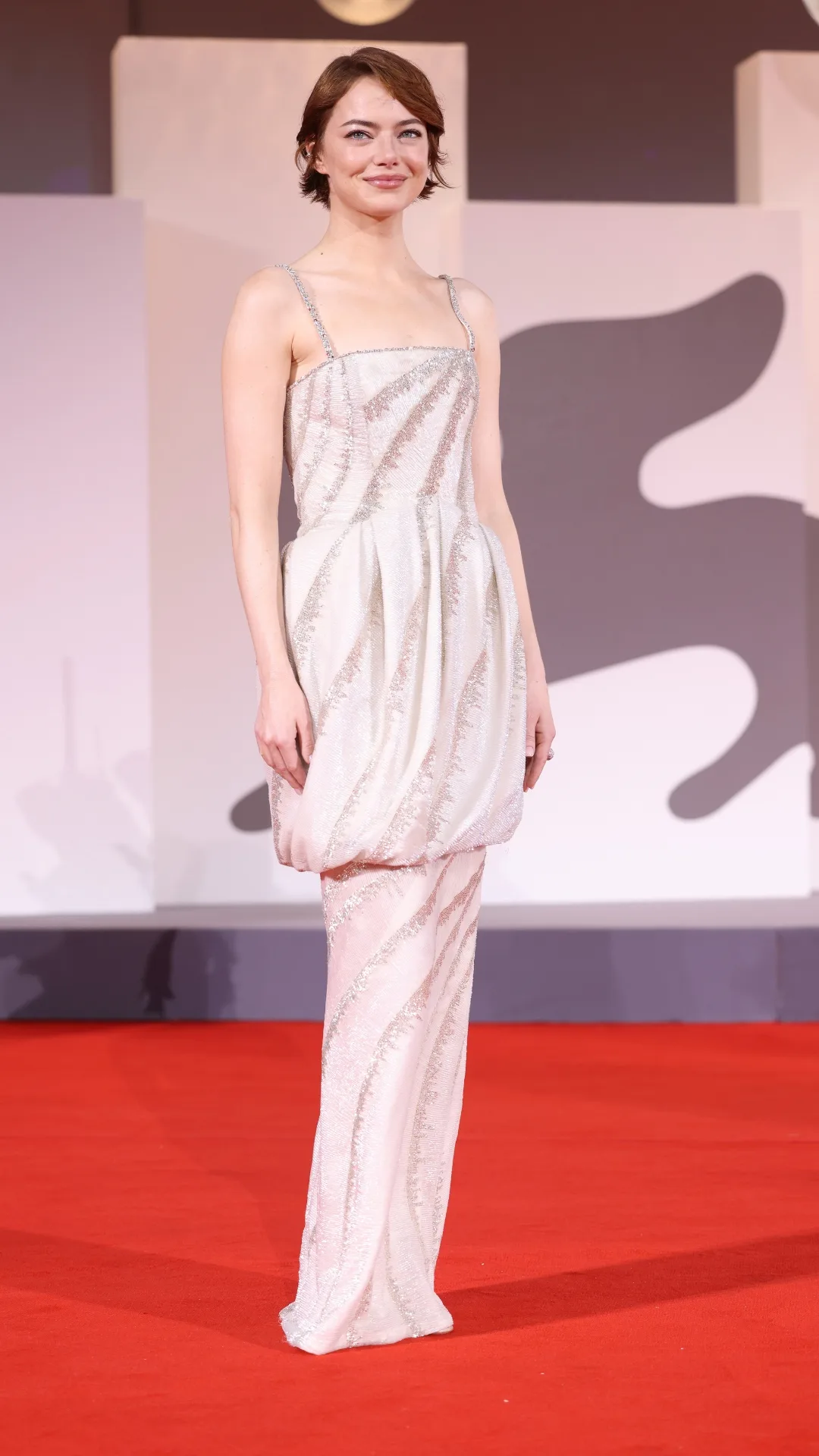 Emma Stone in a custom Louis Vuitton column dress at Venice Film Festival 2025.