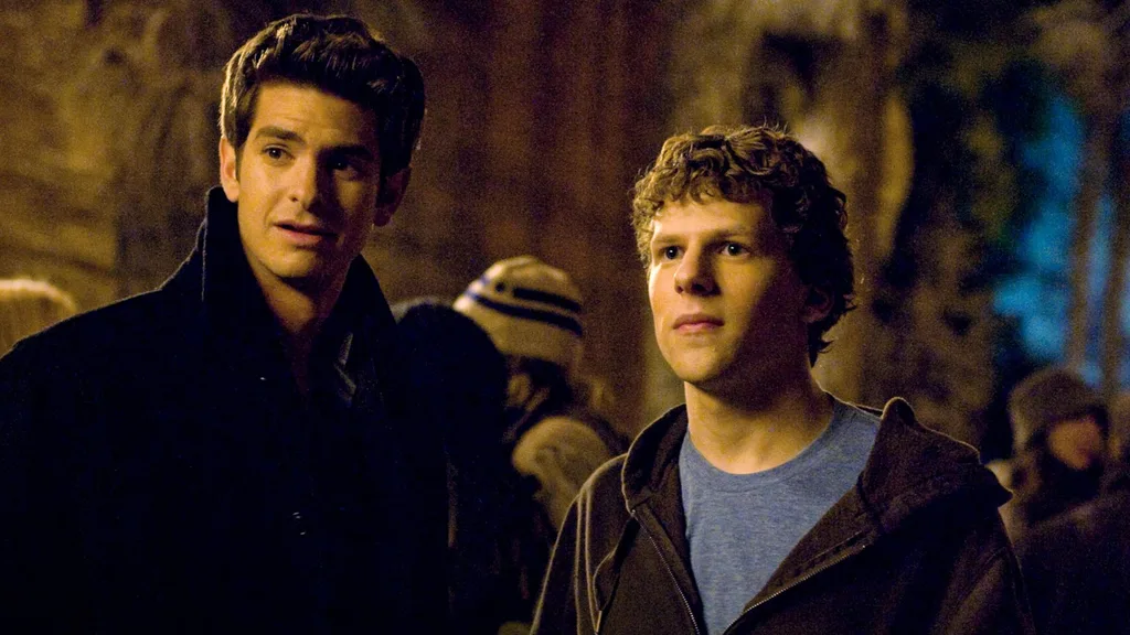A film still from The Social Network depicting two men wearing a casual clothes standing outside at night.