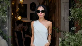 Zoe Kravitz in a silver cocktail dress and silver jewellery showing what to wear to a wedding