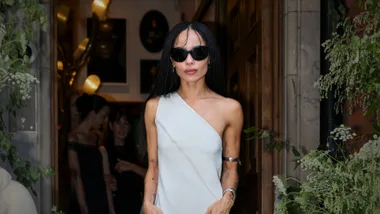 Zoe Kravitz in a silver cocktail dress and silver jewellery showing what to wear to a wedding