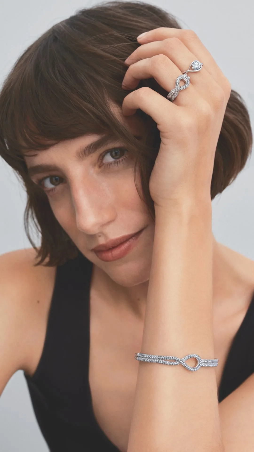 Model wearing Pandora Infinite Pave collection bracelet and earrings