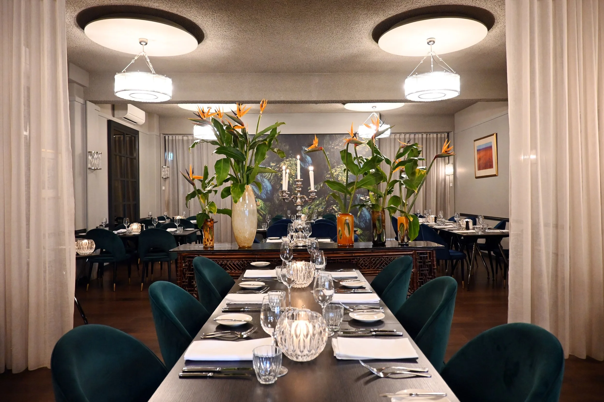 Inside The Peacock Room: jewel-toned velvet, glittering chandeliers, and theatrical floral displays set the stage for a night of glamour.