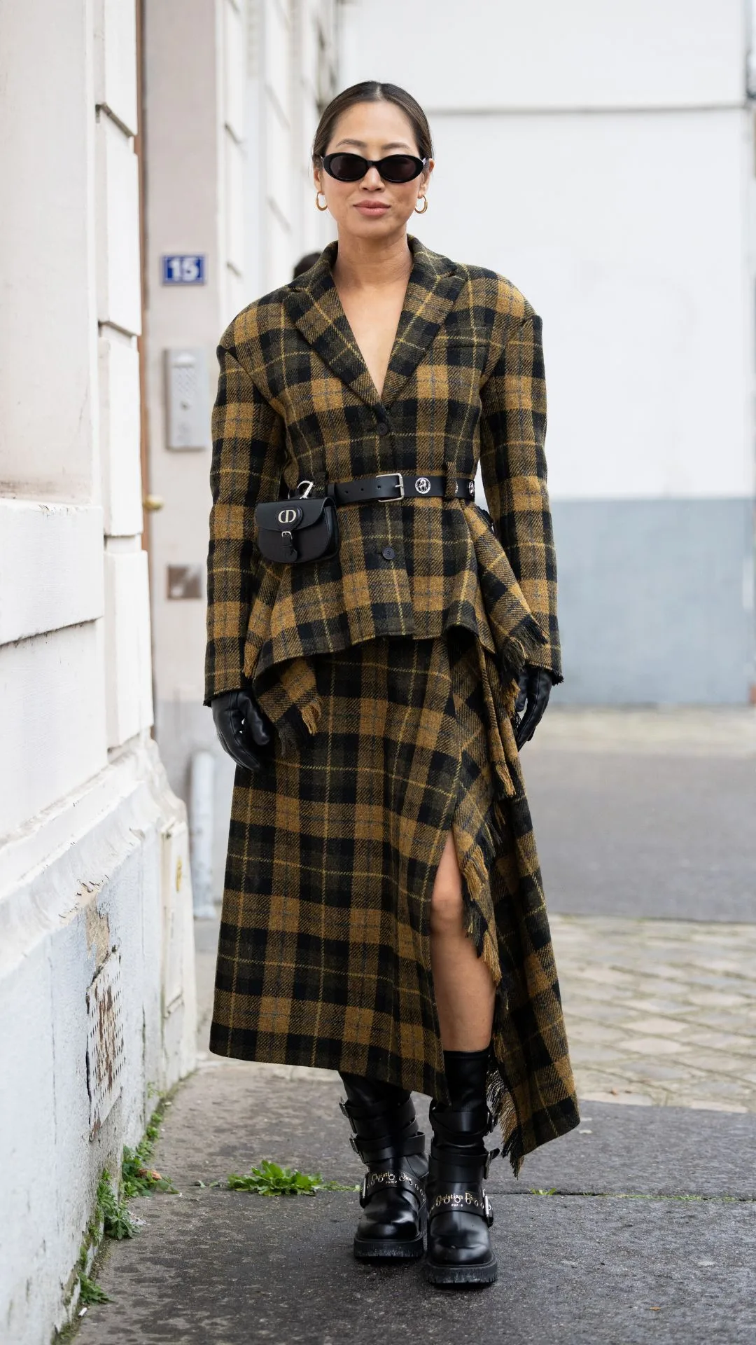 woman wears combat ankle boots with tartan ensemble