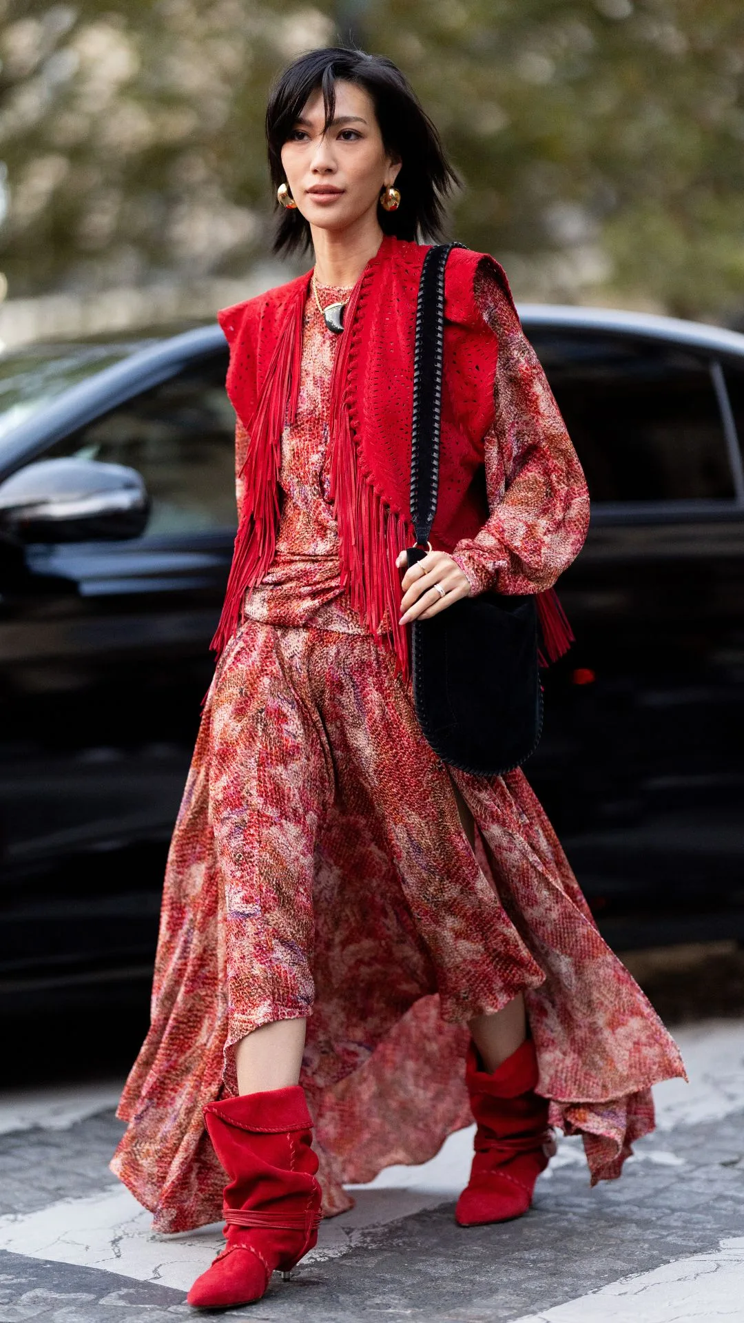 woman wears red slouchy ankle boots with red bohemian maxi dress