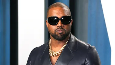 A picture of Kanye in sunglasses on the Grammy's red carpet. Via Getty,