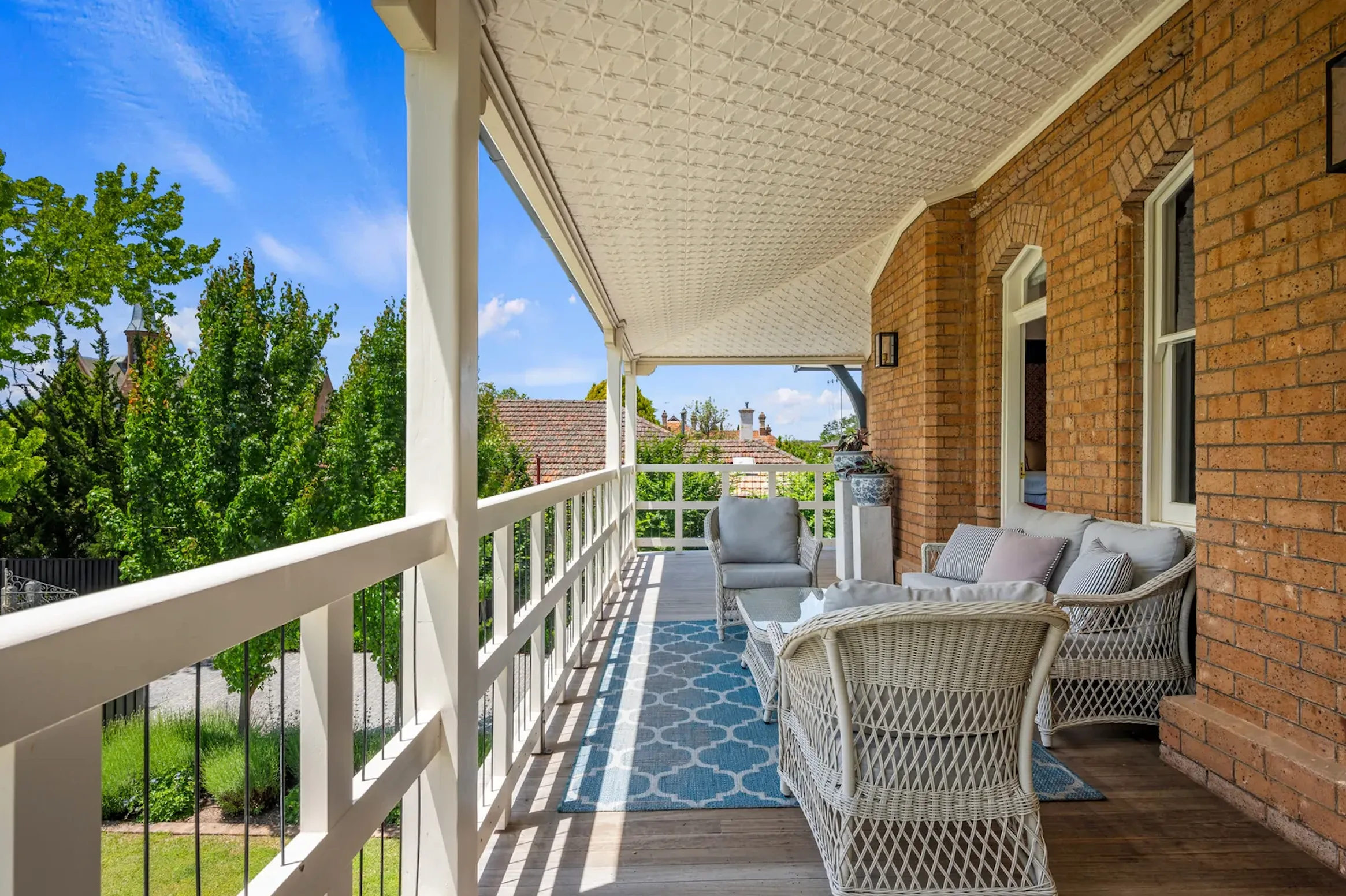 The private veranda of the Yallungah Suite, overlooking manicured gardens — the perfect spot for morning coffee or golden hour Chardonnay.