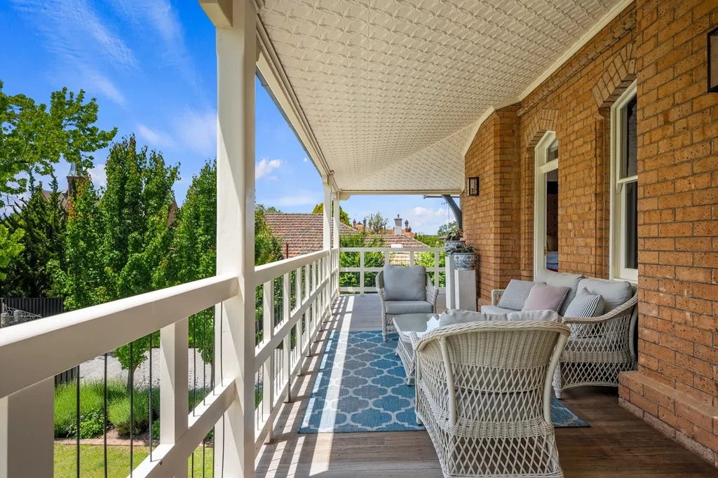 The private veranda of the Yallungah Suite, overlooking manicured gardens — the perfect spot for morning coffee or golden hour Chardonnay.