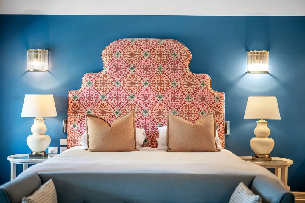 The heritage-meets-modern Yallungah Suite, blending original details with playful textiles — including patterned headboards and jewel-toned walls.