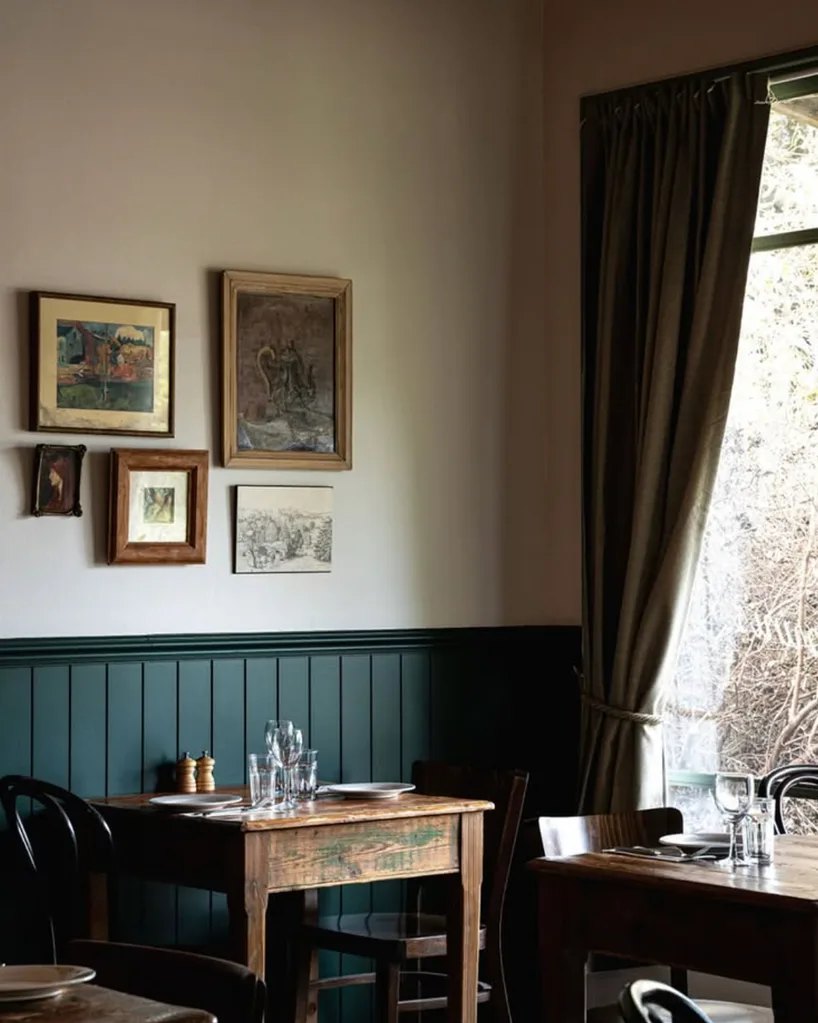 Inside, it’s all dark-green timber, mismatched chairs and vintage artworks. Simple, heartfelt, and filled with charm.