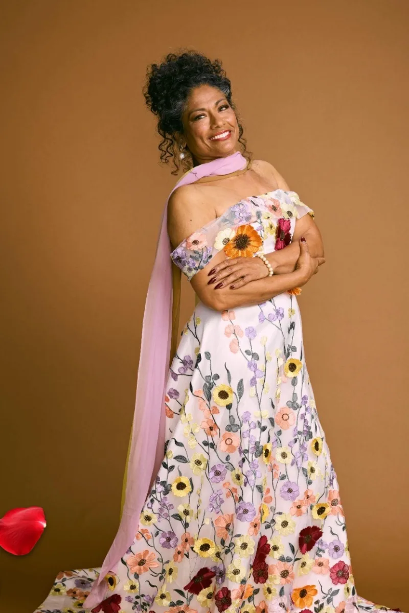 A still of contestant Shamse in a floral, off shoulder gown via 'The Golden Bachelor Australia'.