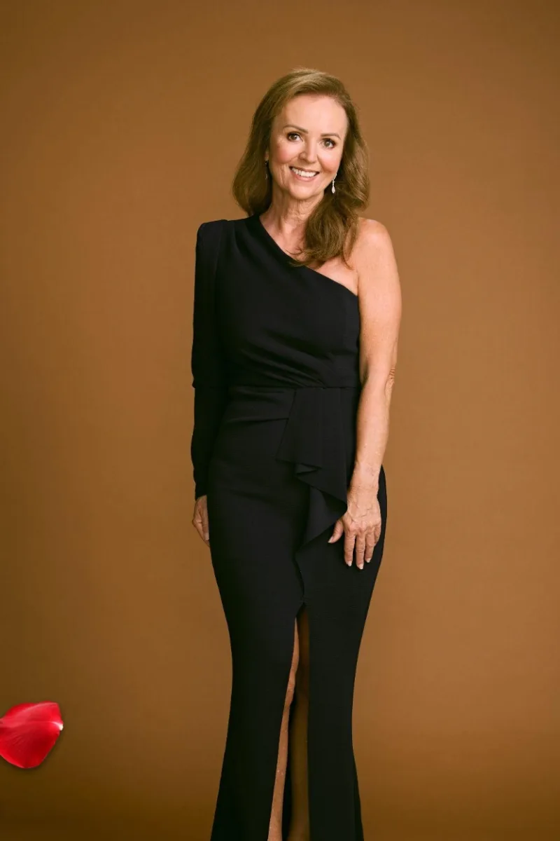 A still of contestant Shana in a black off shoulder gown via 'The Golden Bachelor Australia'.