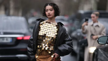 what to wear to a concert example of woman in gold top and leather jacket