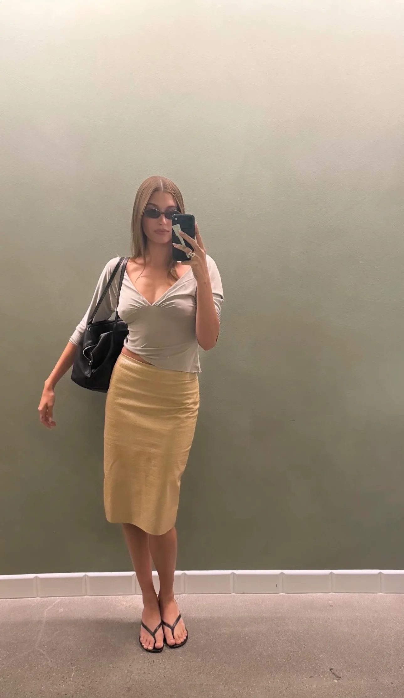 Hailey Bieber wears grey with jean top and yellow skirt