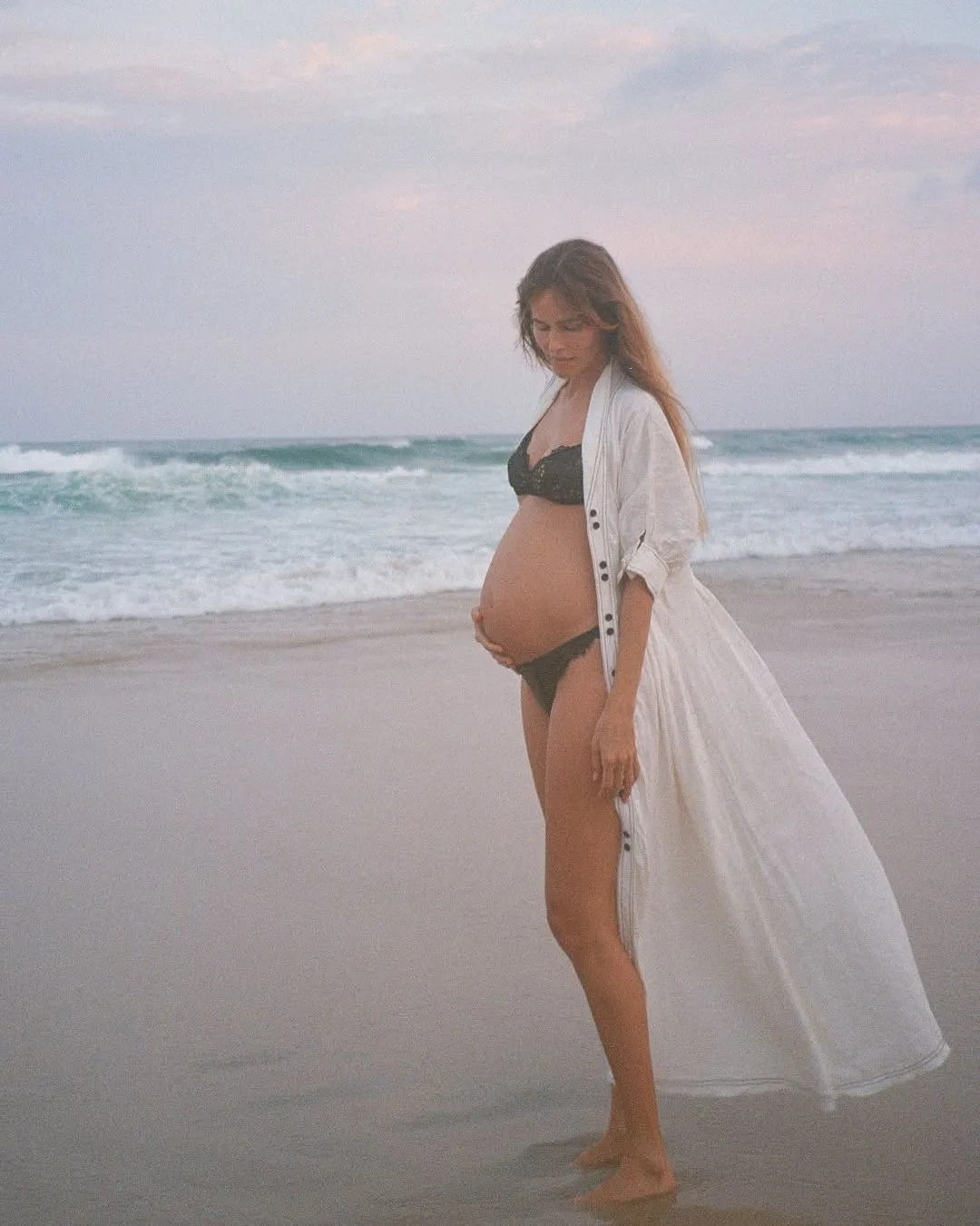 isabel lucas pregnant and showing off her baby bump in a white linen dress and black underwear