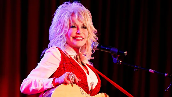 Dolly Parton in red top on stage