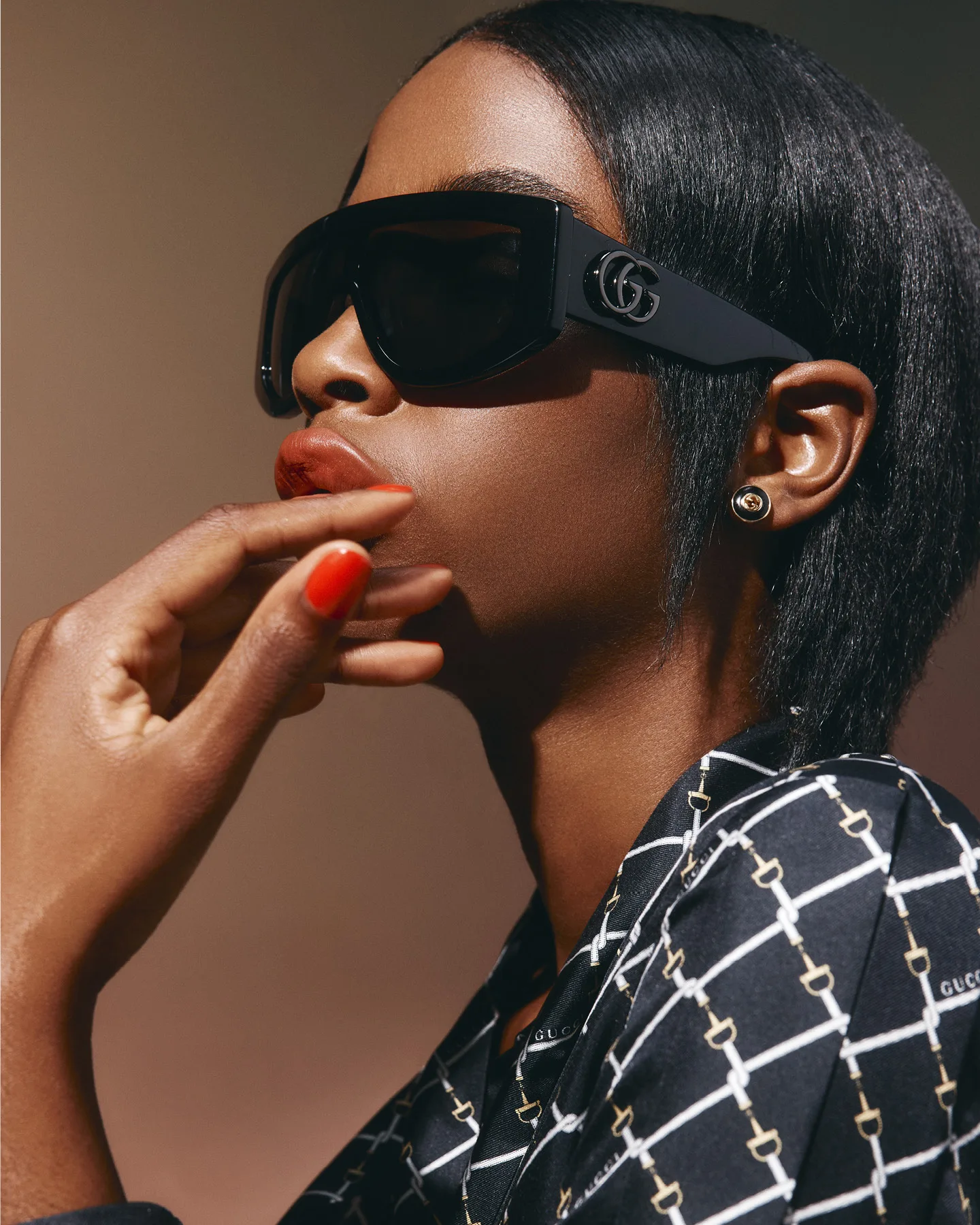 Gucci sunglasses, $790, dress, $5600, and earrings, $3350.